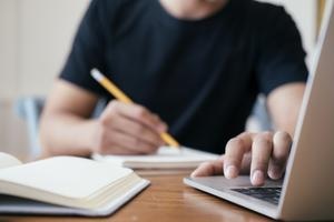 Student sitting at a desk studying for the SAT or ACT